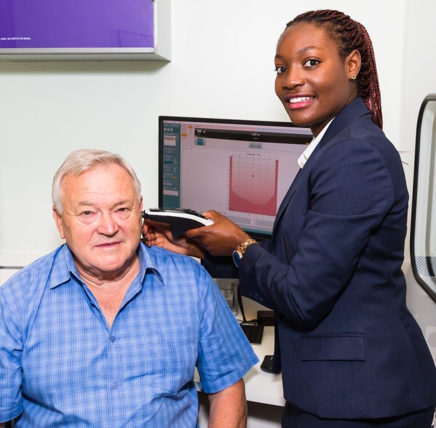 Naa Armah with a client at Specsavers Auidiology Centre in Parramatta.